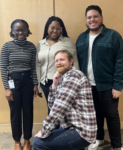 four people posing for a photo